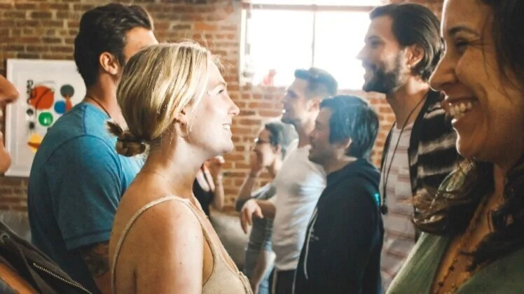 Guests talking and laughing together at one of Veronica's curated in person experiences