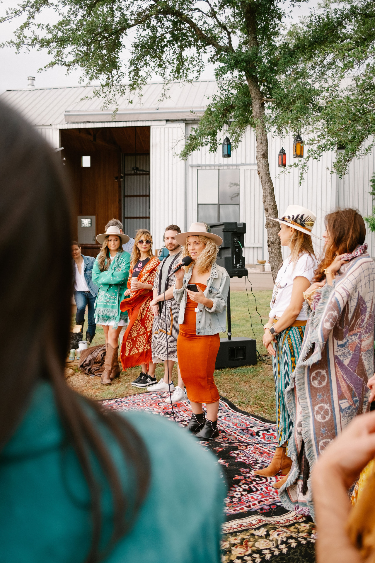 Veronica speaking to a circle of guests gathered outdoors at one of her retreat experiences